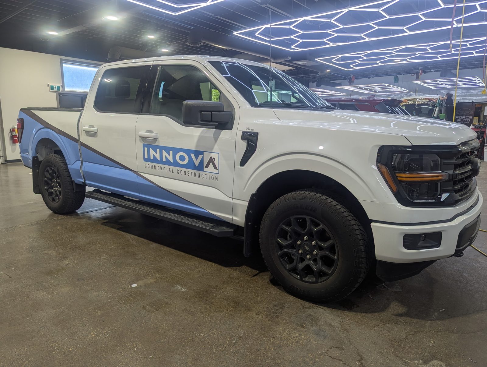 Innova Commercial Construction pickup with KingSkinz fleet graphics